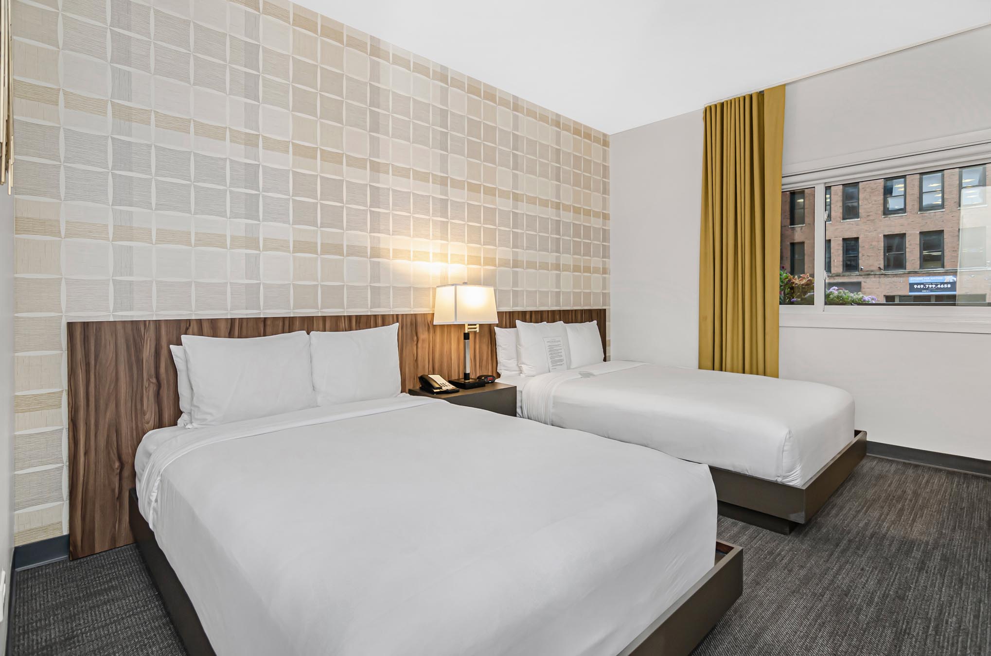 Two double beds and side tables with lamp