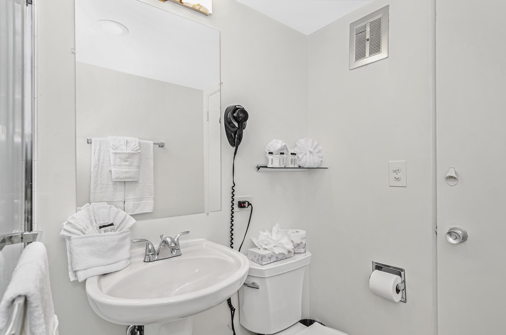 Bathroom vanity with mirror and mounted hair dryer