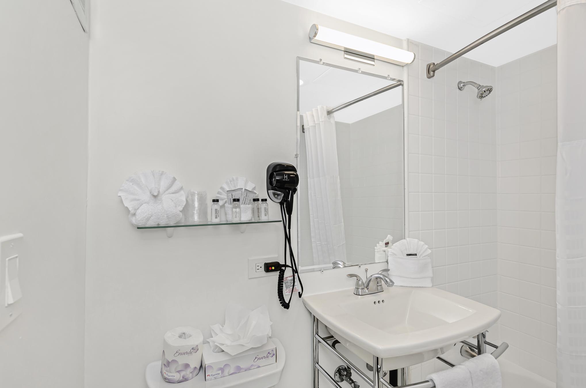 Bathroom vanity with mirror and mounted hair dryer
